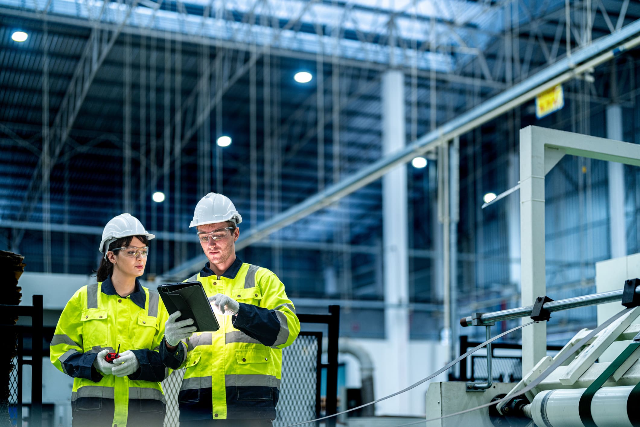 Industrial workers reviewing plans on tablet