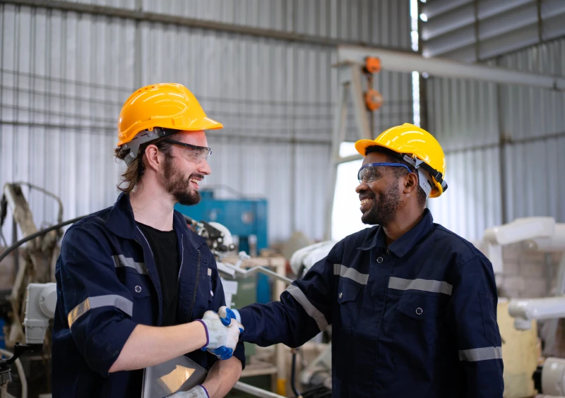 Workers shaking hands in a factory