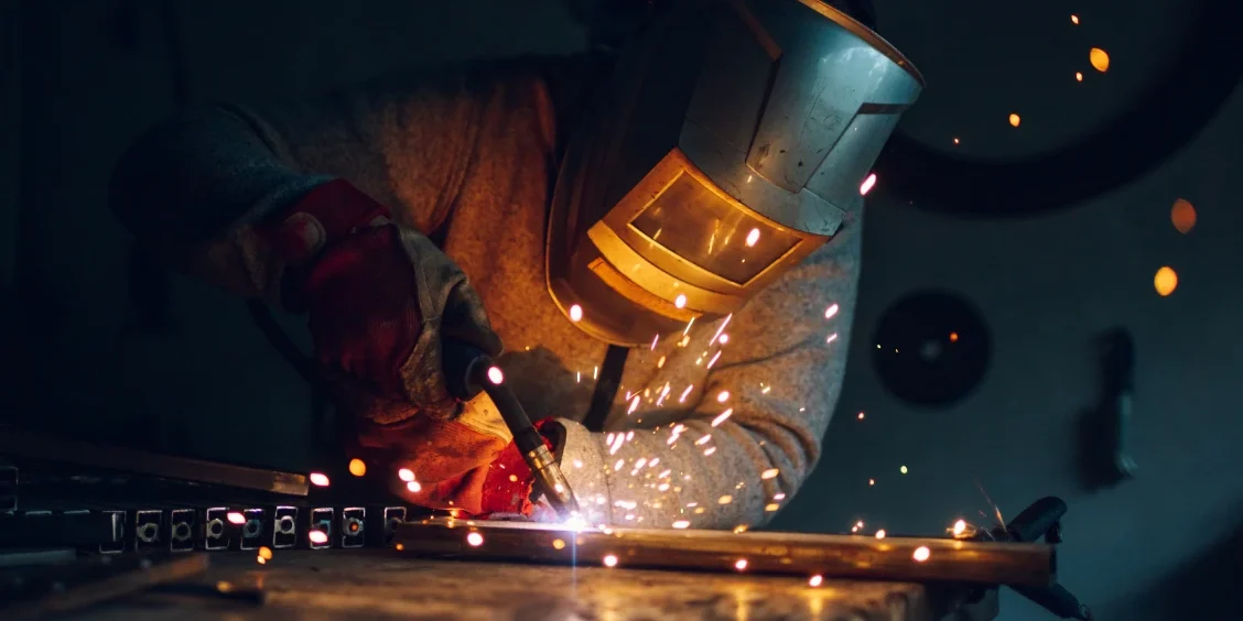 Welder working with sparks flying